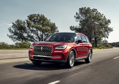 A 2024 Lincoln Corsair® SUV is shown being driven on a country road. | Golden Circle Lincoln in Jackson TN